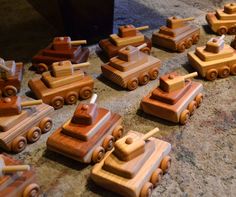 many wooden toy cars are lined up on the floor next to each other and ready to be played