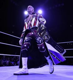 a wrestler standing in the middle of a wrestling ring