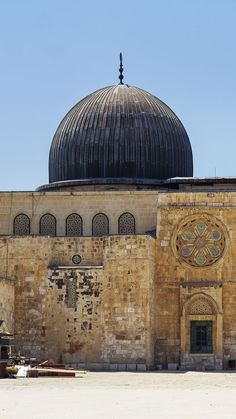 an old building with a black dome on top