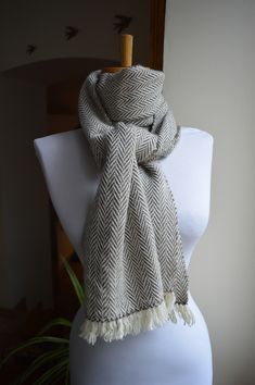 a white mannequin with a scarf on it