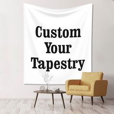 a white wall tapestry with the words custom your tapestry on it and a chair in front