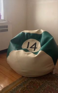 a bean bag chair sitting on top of a wooden floor next to a radiator