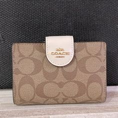 Nwt Coach Medium Zip Wallet Details: Signature Coated Canvas And Smooth Leather Seven Credit Card Slots Bill Compartment Id Window Snap Closure Zip Coin Pocket 5in (L) X 3 1/2in (H) X 1/2in (W) Classic Cream Wallets For Daily Use, Coach Beige Wallet For Formal Occasions, Designer Beige Wallets For Everyday Use, Designer Everyday Beige Wallets, Designer Beige Wallet For Daily Use, Designer Beige Wallets For Everyday, Classic White Wallets For Daily Use, Cream Wallets For Everyday Use, Classic White Wallet With Removable Pouch