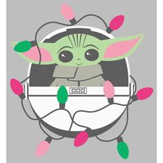 the child yoda is sitting in front of some christmas lights and wearing headphones