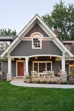 a gray house with white trim and windows