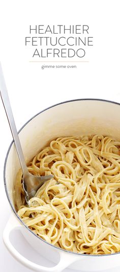 a white pot filled with pasta and a spoon in it's side, on a white background