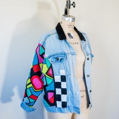 This vintage denim jacket has 80s energy through and through. Featuring a black velvet collar and hand-painted geometric designs up the front and down the right arm, sis looks good with anything. "Scattered" is an upcycled flea-market gem; it's one of a kind, pre-broken-in, AND planet-friendly. All this so you can steal the show AND feel extra extra good about your purchase. Product Details: Upcycled denim jacket Silver snap closures Side pockets Faux breast pockets Classic side pockets Black ve 80s Denim Jacket, 80s Denim, 80s Jacket, Velvet Collar