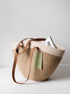 Embrace summertime style with our handmade jute rope tote, a versatile accessory perfect for beach days, market outings, and everyday adventures. Crafted with durable jute rope, this spacious tote offers ample room for all your essentials. Its laid-back yet chic design makes it ideal for strolling through the city or lounging by the shore.  Large jute tote, inspired by Scandinavian design, perfect for shopping or beach outings. Its natural color complements any outfit effortlessly. Crafted from Summer Canvas Tote With Braided Handles, Handmade Eco-friendly Canvas Bag For Summer, Sand-colored Straw Tote Bag, Summer Beach Canvas Bag With Leather Handles, Everyday Sand-colored Straw Tote Bag, Neutral Tote Beach Bag, Beige Canvas Bag With Leather Handles For Beach, Summer Beige Bucket Beach Bag, Neutral Summer Beach Tote Bag