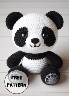 a crocheted panda bear sitting on top of a wooden floor with the caption free pattern