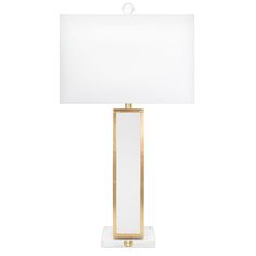 a lamp with a white shade on it and a gold frame around the light fixture