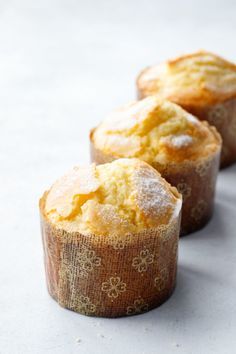 three muffins with powdered sugar on them are lined up in a row