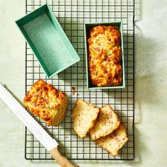 some food is sitting on a cooling rack next to a cutting board and a knife