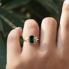 [In finger front view of dark green emerald cut moissanite engagement ring]-[Golden Bird Jewels] Emerald Ring Marquise, Dark Green Emerald Engagement Ring, Dark Green Emerald Ring, Dark Green Stone Ring, Dark Green Rings, Dark Emerald Engagement Ring, Dark Green Engagement Ring, Elegant Marquise Cut Emerald Ring, Elegant Marquise Emerald Ring