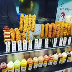 corn on the cob and other food items in a display case at a store