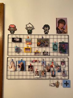 there is a metal rack with pictures and magnets attached to it on the wall