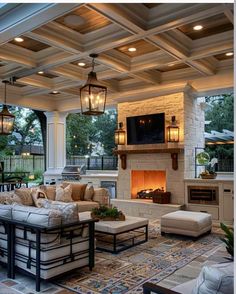 a living room filled with furniture and a fire place under a tv mounted on a wall