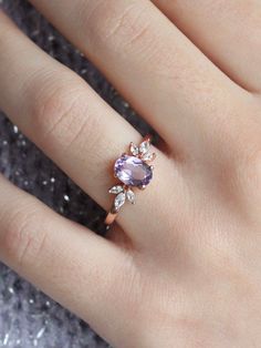 The immaculate vibes of our Contessa Ring are absolutely unmatched. ✨ The pristine and opulent amethyst crystal is framed by two delicate cubic zirconia blossoms in this delicate design. Delicate and regal, unique yet versatile, the Contessa Ring is a unique and stunning addition to any jewelry collection. 💜 Complete the look with our Tiara Stacker, Arc Stacker or Sweetheart Stacker! * * * Don't know your ring size? View our Ring Size Guide * * * …………………………………. RING SIZE & MATERIAL❋ 18k rose go Elegant Amethyst Ring With Gemstone Accents For Promise, Delicate Gemstone Jewelry For Anniversary, Elegant Amethyst Crystal Ring With Center Stone, Elegant Amethyst Crystal Ring With Gemstone Accents, Elegant Purple Birthstone Ring With Gemstone Accents, Elegant Amethyst Diamond Ring With Gemstone Accents, Elegant Amethyst Crystal Ring With Accent Stones, Dainty Amethyst Wedding Ring With Prong Setting, Exquisite Amethyst Jewelry With Center Stone