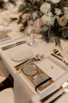 the table is set with silverware and place settings for an elegant wedding reception,