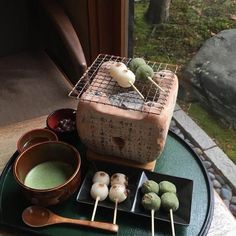 some food is sitting on a tray with chopsticks and bowls next to it