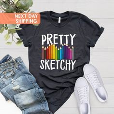 "Pretty Sketchy Shirt, Artist Shirt, Artist Gift, Art T-shirt, Art Teacher Gift, Painting Shirt, Painter Shirt, Sketching Shirt, Art Lover BLACK TEXT is used by for Yellow, Heather Peach, White, Light Gray Heather Shirts. WHITE TEXT is used by Other Colored Shirts. Hi! Welcome. It's great to see you here! ☺️  Our shirts are clean, high quality and soft. It is prepared quickly by our boutique.  Ironing and shipped.  Enjoy your shopping!  It is a pleasure for us to help you with your questions and Crayon Shirt, Shirt Sketch, Gift Painting, Art Teacher Gifts, Artist Shirts, Paint Shirts, T Shirt Art, Shirt Art, Art Shirt