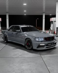 a silver car parked in front of a gas station