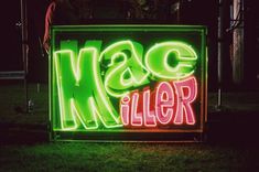 a neon sign that says mac miller on it