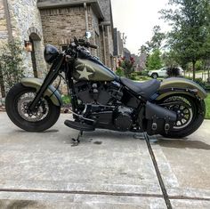 a motorcycle parked in front of a brick building with a star on the back tire