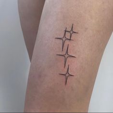 a woman's thigh with three crosses tattoo on her left side ribcage