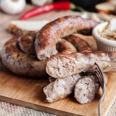 sausages on a cutting board with a fork