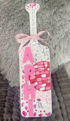 a pink and white bottle with the word love on it