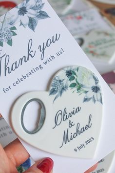 a white heart shaped keychain with a thank you tag attached to the front