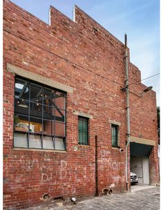 an old brick building with graffiti on it