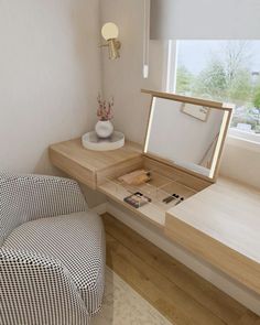 a chair and desk in a small room with a mirror on the wall above it