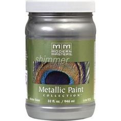 a jar of metallic paint with a white lid and blue peacock feathers on the side