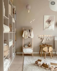 a baby's room with lots of shelves and toys on the floor in front of it