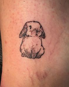 a small rabbit tattoo on the ankle