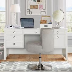 a white desk with a laptop on top of it and a lamp next to it