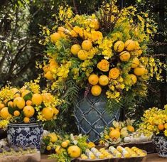 a table topped with lots of yellow flowers and lemons on top of each other