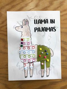 a llama in pajamas made out of paper on top of a piece of paper