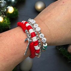 Festive Christmas Bracelet Stack - "Ho Ho Ho" Beaded Holiday Bracelet Set Bring a cheerful touch to your holiday style with this vibrant Christmas bracelet stack! Featuring four unique bracelets in classic holiday colors of red, white, and green, this festive stack is perfect for spreading Christmas spirit wherever you go. Each bracelet is made from high-quality beads, with a fun mix of designs that include striped, solid, and multi-colored patterns, creating a delightful holiday-themed look. Features: "Ho Ho Ho" Bead Design: This stack includes a focal bracelet with white beads spelling out "Ho Ho Ho," adding a playful nod to Santa's iconic laugh. It's perfect for anyone who loves celebrating the season! Holiday Color Palette: With a harmonious blend of red, green, and white beads, these Bracelet Diy Ideas, Holiday Color Palette, Holiday Bracelet, Beaufort Nc, Heishi Bracelets, Bracelet Stacks, Halloween Bracelet