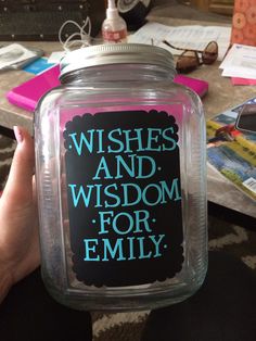 a person holding up a jar with the words wishes and wisdom for family on it