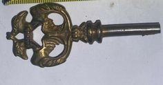 an antique door handle with a measuring tape behind it