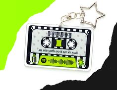 a keychain with an old school cassette tape design on it and a star hanging from the front