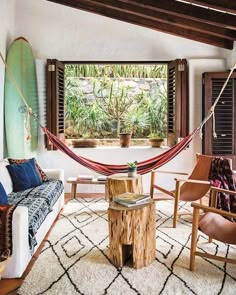 a living room filled with furniture and a hammock