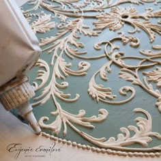 an intricately designed rug is being worked on