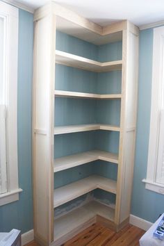 a living room filled with furniture and lots of shelves