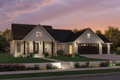 this is an artist's rendering of the front elevation of a house at dusk