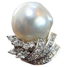 Indulge in luxury with this 14K White Gold Diamond Pearl Ring. Weighing 9 grams and perfectly sized at 5.5, this exquisite piece features a radiant pearl surrounded by sparkling diamonds, all set in solid white gold. A timeless addition to any jewelry collection. Weight: 9 g Size: 5.5 Material: 14K Solid White Gold Sell Price: $999 Appraisal Price: $2000 A free Online Diamond appraisal is included upon request Luxury Exquisite Diamond Pearl Ring, White Pearl Ring With 17 Jewels For Formal Occasions, Formal White Pear-shaped Diamond Ring, White Pearl Ring With Diamond Accents In Platinum, White Pearl Platinum Ring With Diamond Accents, Formal Diamond Pearl Ring With High Luster, White Gold Pearl Ring With High Luster Diamonds, Diamond Pearl Ring, Pink Pearl Ring