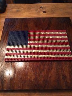 an american flag made out of legos on a wooden table