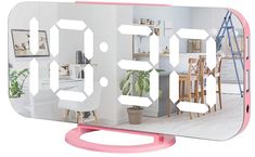 a mirror that has the reflection of a room in it, and is shaped like a clock